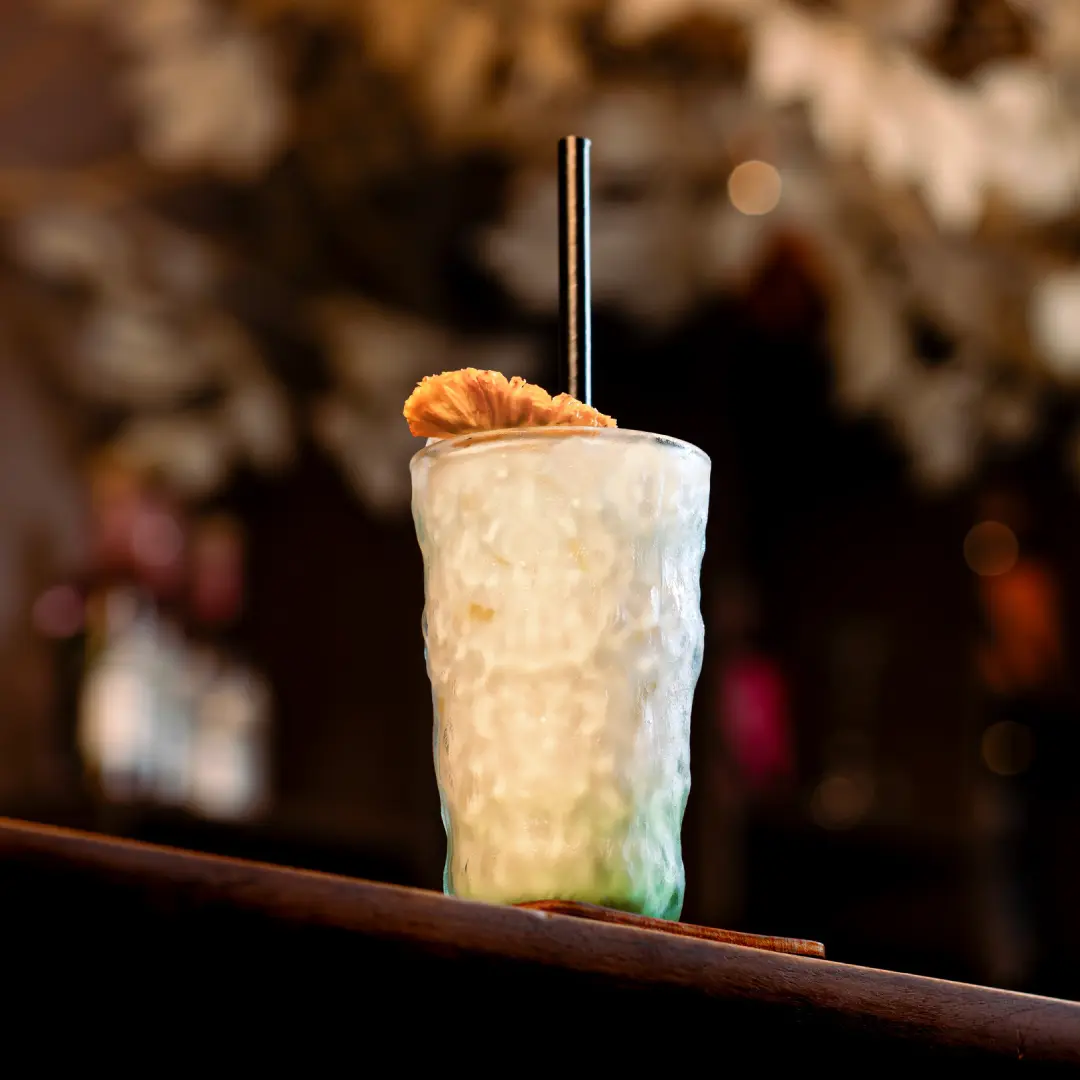 Cocktail beside a bar menu